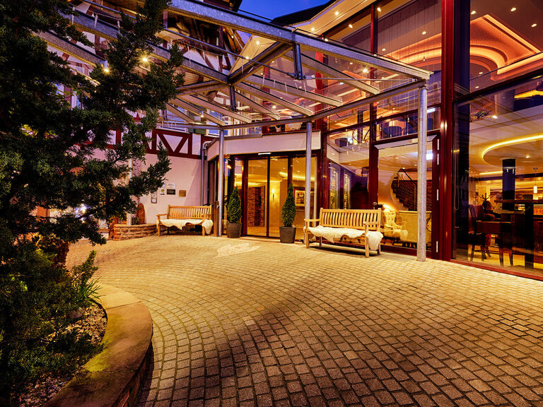 The hotel approach with the hotel entrance at dusk.