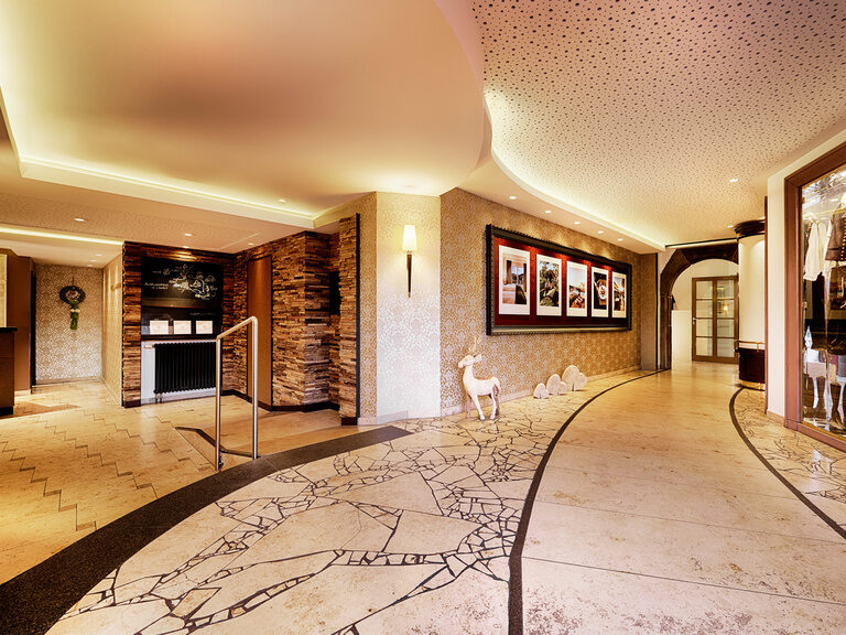 beige hallway that splits into two directions.
