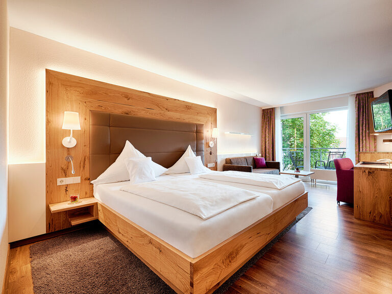 Hotelzimmer Zavelstein der Kategorie Klassik im Wellnesshotel Kronelamm im Schwarzwald. Großes Bett im gemütlichen, lichtdurchfluteten Hotelzimmer im Hotel Kronelamm im Schwarzwald.