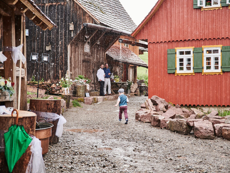 A boy runs past various buildings on the Theurerhof estate.
